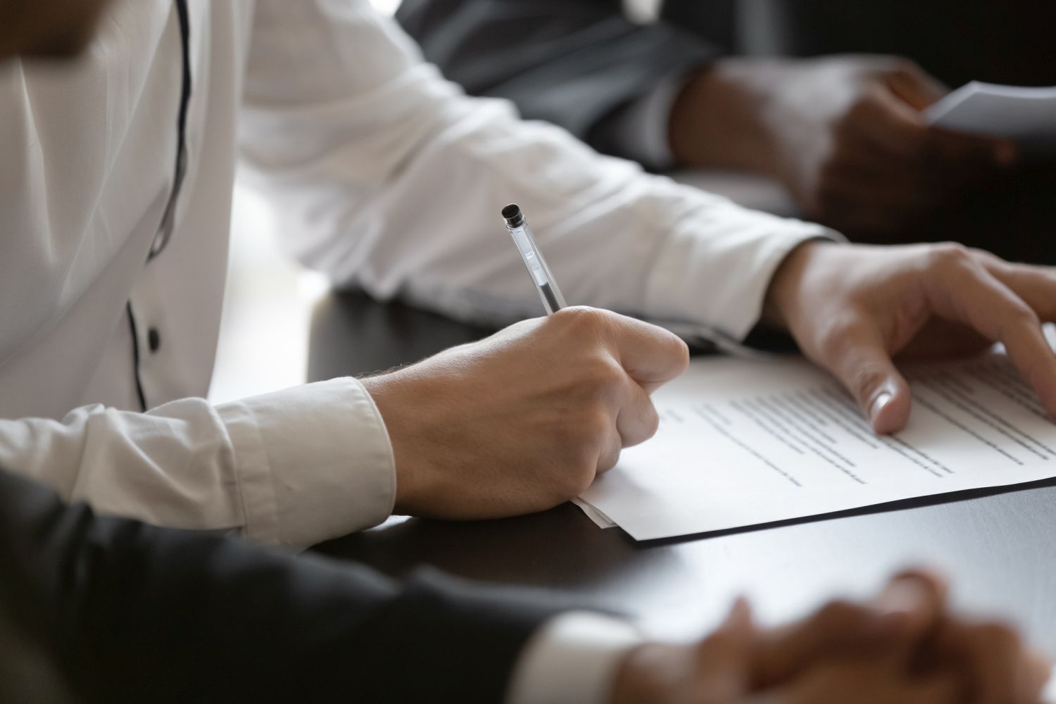 close up young male manager hands signing contract.